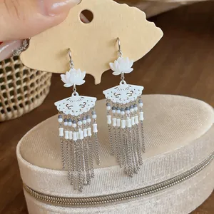 Detail view of New Chinese style fan-shaped earrings with elegant long white tassels