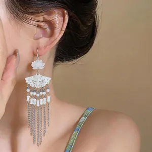 Close-up detail view of New Chinese style fan-shaped earrings with long tassels
