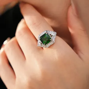 Detailed close-up of vintage geometric ring featuring a square emerald green zircon