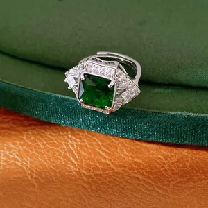 Detailed macro view of an elegant square emerald green zircon ring with crystal halo