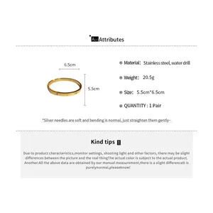 Gold stainless steel bangle with heart engraving and zircon accents, detail view with specs