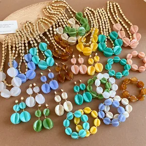 Assorted colorful acrylic necklaces and earrings set with gold beads for summer vacation