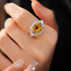 Detailed view of an exquisite geometric square open ring with a brilliant yellow zircon.