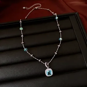 Luxury silver-toned necklace featuring a square blue zircon pendant and sparkling beads