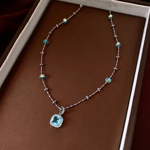 Luxury zircon pendant necklace with blue gemstone and iridescent beads on silver chain