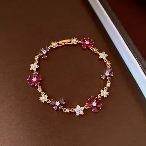 Elegant gold-plated bracelet featuring zircon flowers and cross charms for stylish women