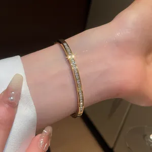Close-up of an elegant gold bangle encrusted with shimmering cubic zirconia on a wrist