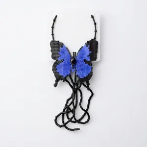 Geometric blue and black beaded butterfly necklace with trendy pixel design on white background
