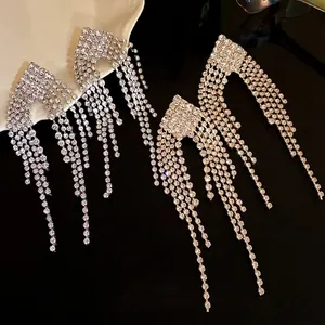 Elegant rhinestone tassel drop earrings with geometric diamond-shaped tops in gold and silver.