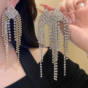 Macro view of sparkling silver tassel earrings featuring long flowing rhinestone chains.