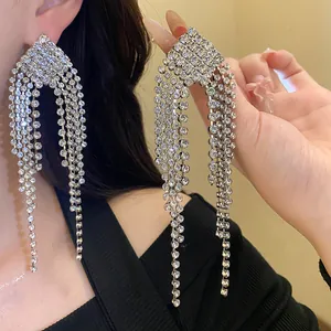 Close-up detail of luxury silver rhinestone tassel earrings with a dazzling diamond sparkle