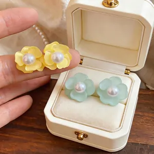 Elegant flower stud earrings with pearl centers and silver needles in pastel colors
