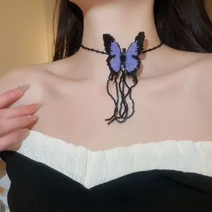 Detailed view of handmade purple beaded butterfly choker necklace with dangling tassels