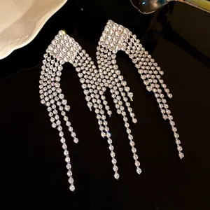 Detailed view of luxury rhinestone tassel earrings with sparkling diamond shape