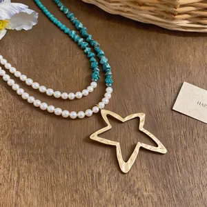 Collar bohemio de capas con perlas blancas, piedras turquesas y colgante de estrella.