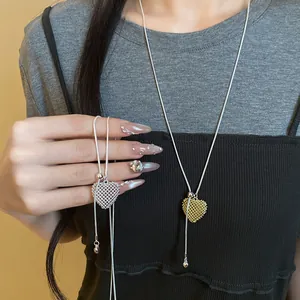 Close-up view of adjustable hollow mesh heart pendant necklaces in gold and silver colors.
