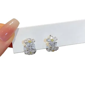 Elegant zircon flower ear cuffs with sparkling white and yellow stones for stylish women.
