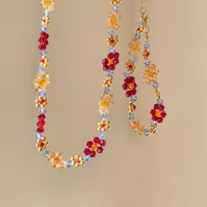 Macro detail of handmade floral beaded necklace and bracelet set with crystal beads