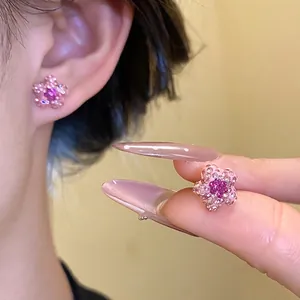 Sparkling soft clay flower earrings with pink rhinestones shown on model