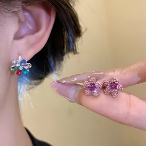 Detail of pink and colorful star-shaped stud earrings with crystal embellishments