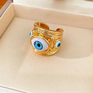 Adjustable gold-plated chunky ring featuring a unique blue resin evil eye design