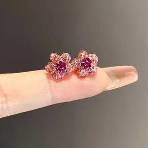 Macro detail view of exquisite pink star-shaped stud earrings with sparkling purple crystals