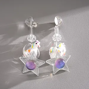 Detailed view of creative resin star earrings featuring a colorful unicorn charm