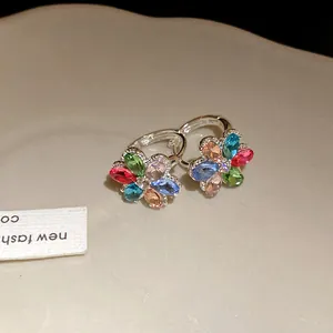 Macro view of colorful floral rhinestone earrings with silver finish