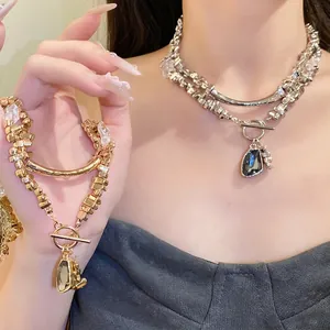Elegant irregular triangle pendant necklace with crystal details and OT buckle style