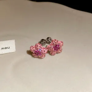 Macro view of pink star earrings with shimmering rhinestones and secure screw backs