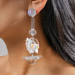 Detailed view of the resin pony and star charms on this unique dopamine style earring