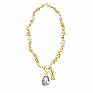 Elegant gold plated necklace with irregular beads and a faceted crystal triangle pendant