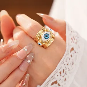 Detailed macro view of an oval evil eye resin ring featuring a gold stacked band design