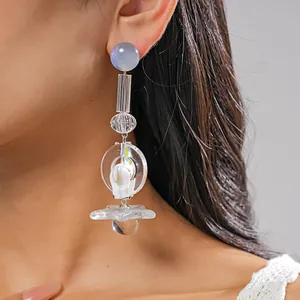 Detail view of multi-element resin earring with unicorn and star shapes on ear.