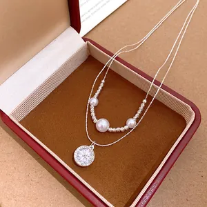 Elegant double-layered necklace with round star zircon pendant and pearls detail view.