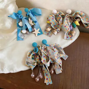 Orecchini a fiocco in chiffon con ciondoli a conchiglia e stella marina a tema oceanico