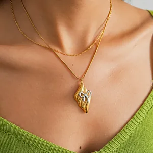 Detailed macro view of a stylish vintage stainless steel bow pendant necklace for women