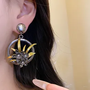 Detailed view of vintage silver floral earrings with delicate gold leaves and crystals.