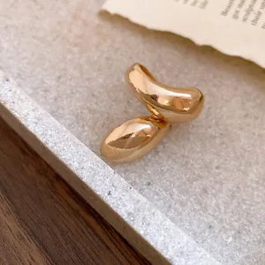 Close-up of gold-finish irregular twisted ring with a droplet design for women.
