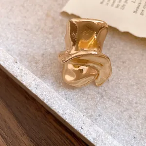 Close-up of a vintage golden irregular twisted water drop ring with a high-shine finish.