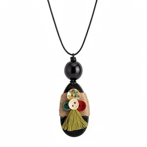 Handmade bohemian wooden oval pendant necklace with twine wrap and green tassel detail