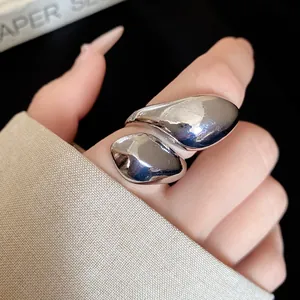 Macro view of an irregular silver water drop twisted metal ring for a retro look