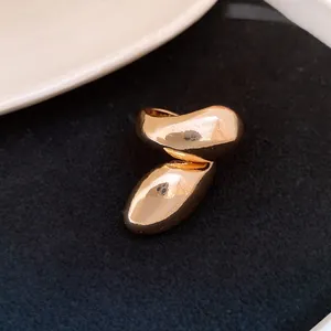 Macro detail of high-polished gold irregular twisted waterdrop ring for vintage fashion look