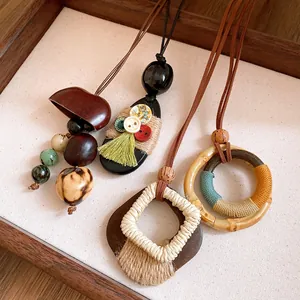 Detail of bohemian necklaces made with wood, faux suede, and woven rope elements.