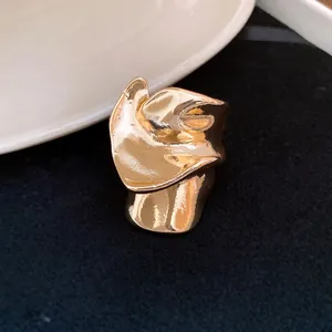 Detailed macro view of an irregular distorted gold metal ring with a molten texture