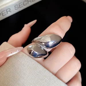Detailed macro shot of an elegant silver irregular twisted droplet metallic ring for women