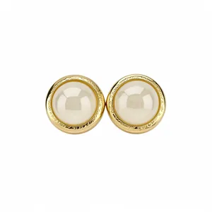 Vintage gold-toned round stud earrings with large pearl-like resin centers
