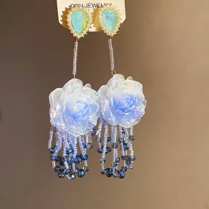 Eleganti orecchini a fiore in resina d'argento con nappe e borchie a goccia blu.