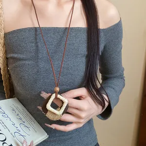 Close-up of a handmade Maillard style wooden diamond pendant necklace with hemp rope