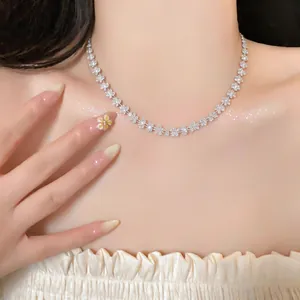 Detailed macro view of an elegant crystal flower necklace on a female model's collarbone